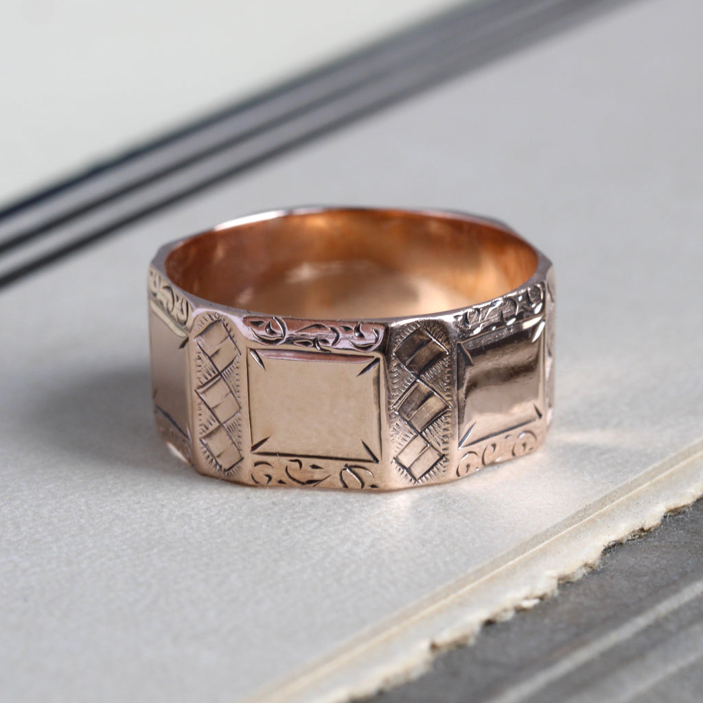 Antique rose gold panel wedding band with etched details on each of the sides. 