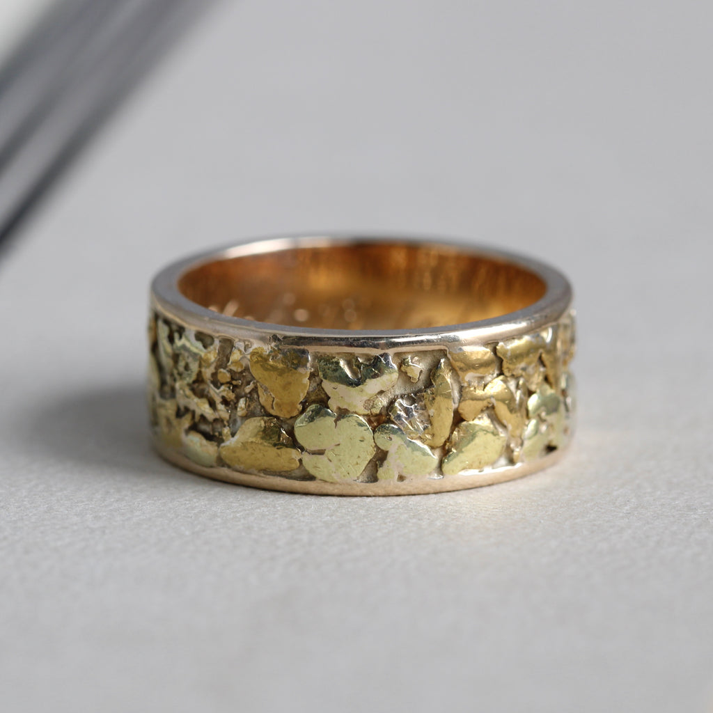 vintage yellow gold nugget band with natural textures and a polished interior.