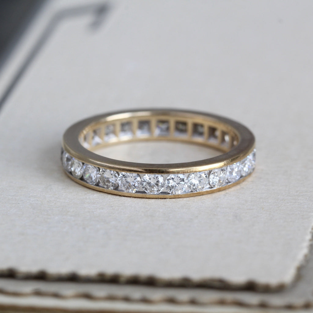 Vintage 14k yellow gold eternity band channel set with diamonds in eternity style.