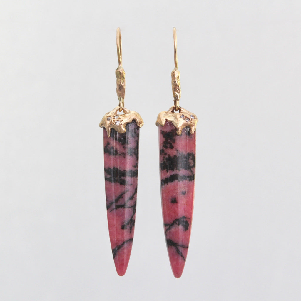 Handmade yellow gold earrings with carved rhodonite spikes and melted gold caps studded with tiny diamonds.