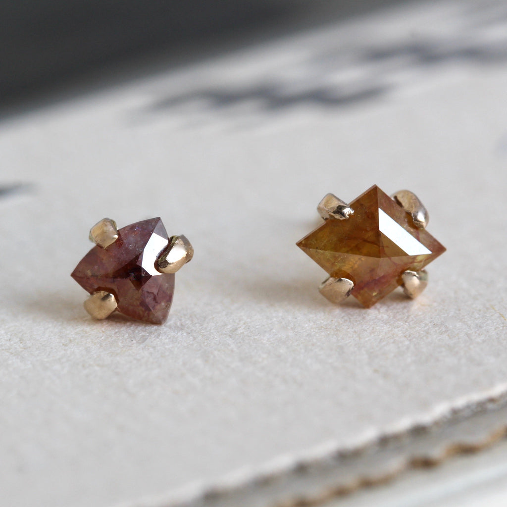 Handmade yellow gold mismatched stud earrings with fancy color rose-cut diamonds.