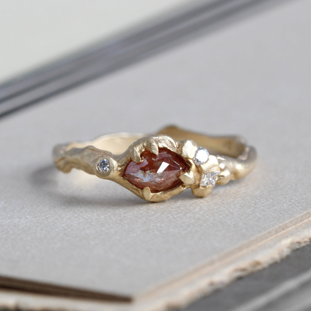 Handmade yellow gold ring with a marquise shaped cinnamon colored fancy diamond with tiny diamonds set in the bezel and a hammered textured shank.