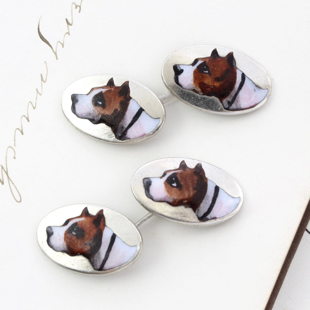 Antique sterling silver cufflinks with enamel dog head paintings on the fronts.