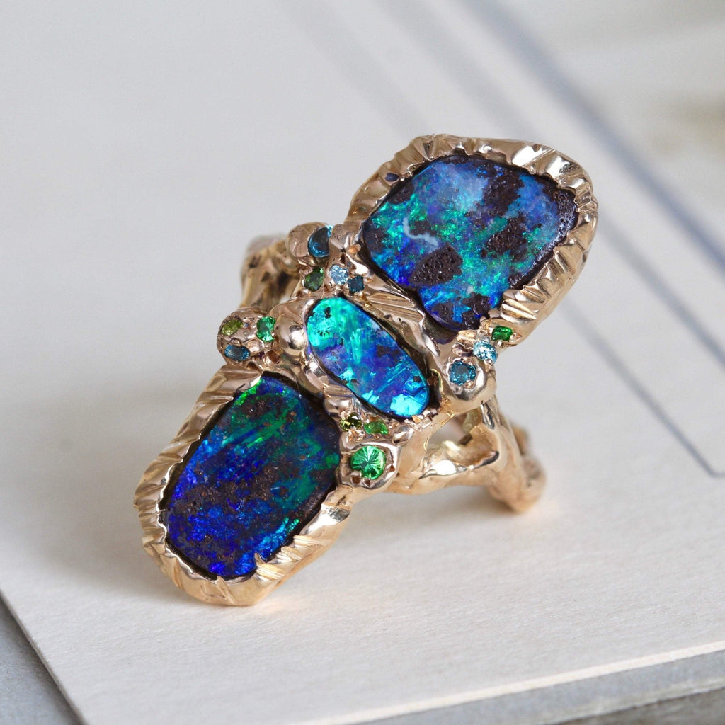 Handmade yellow gold and blue Australian opal and blue topaz statement ring with hammered texture bezel and band.