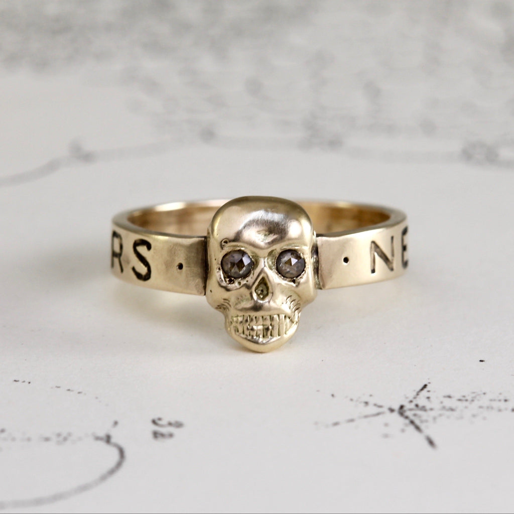 Handmade yellow gold ring with a skull with diamond eyes.