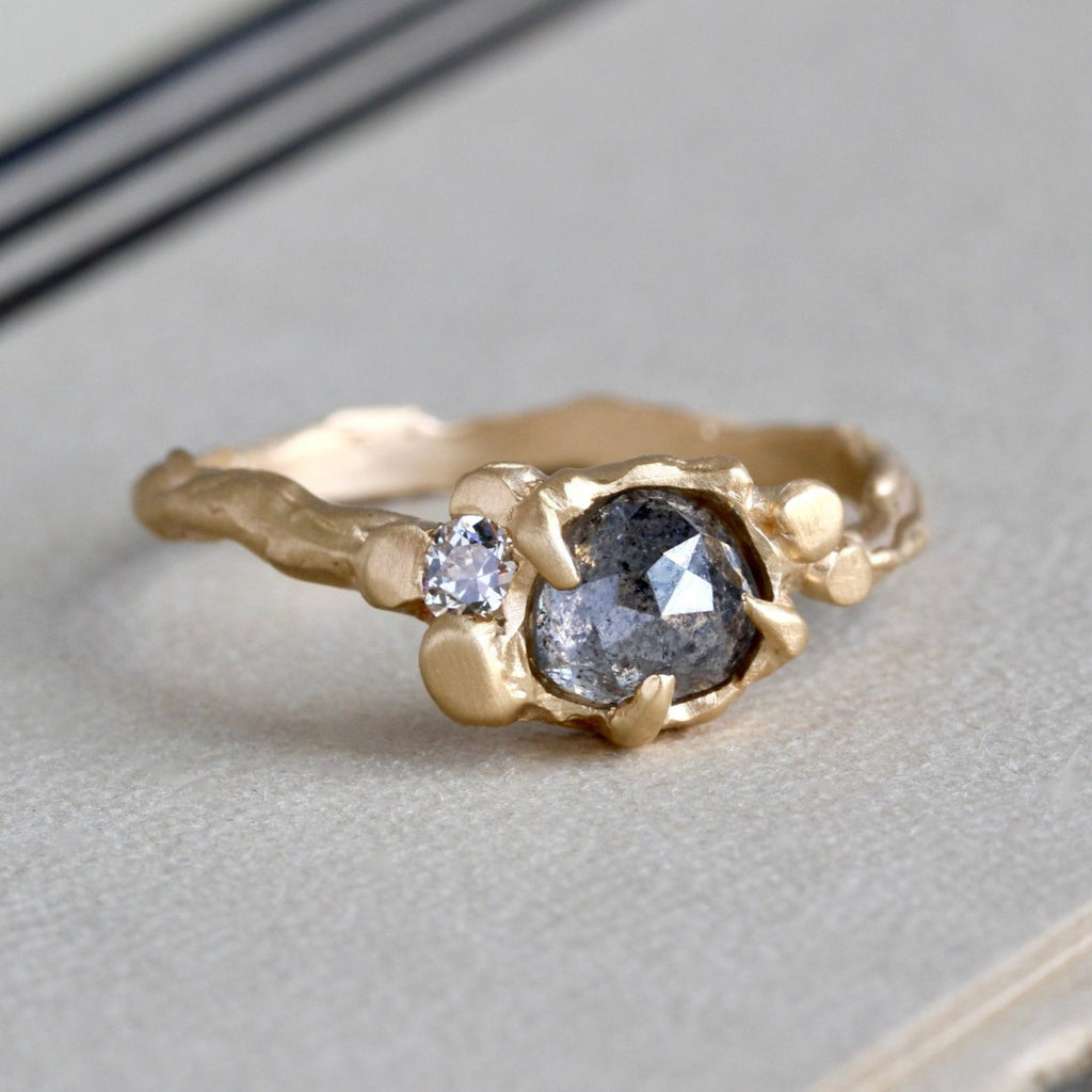 Handmade branch style yellow gold ring with a translucent  grey salt and pepper rose cut diamond accented by a white diamond